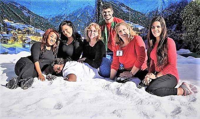 a group of people are posing for a picture in the snow .