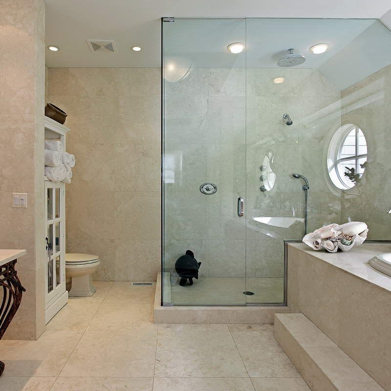 A bathroom with a walk in shower and a bathtub