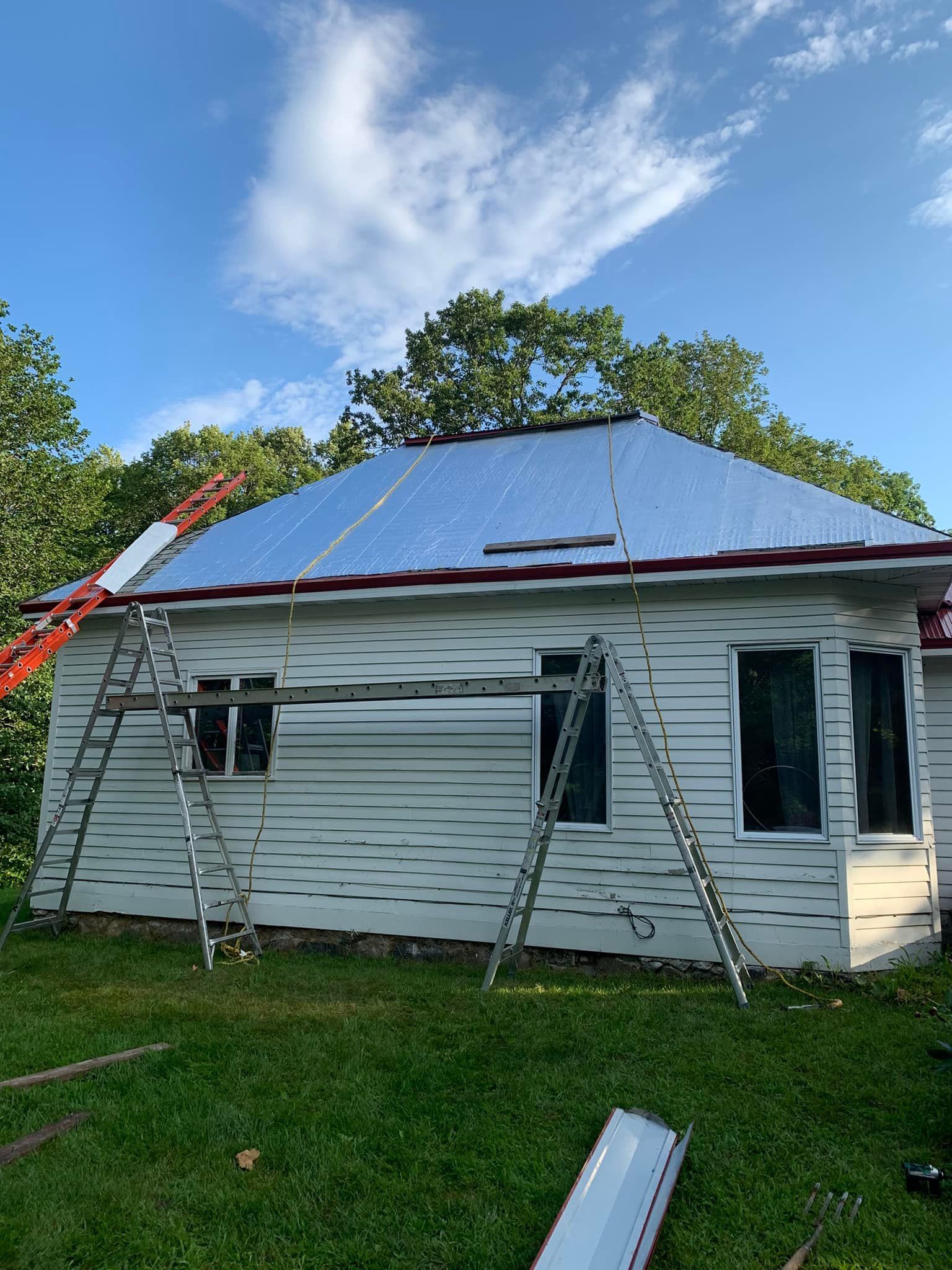 A large gray house with a black roof