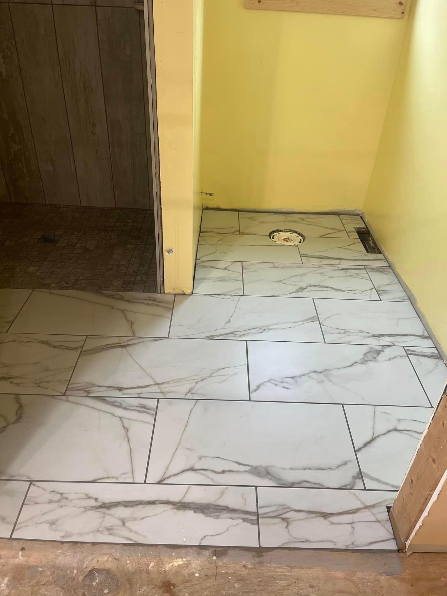 A large gray house with a black roof