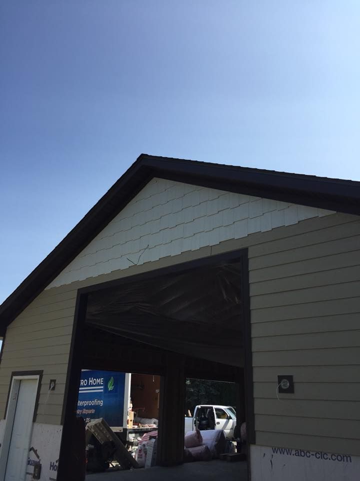 A garage with the door open and a truck parked in it
