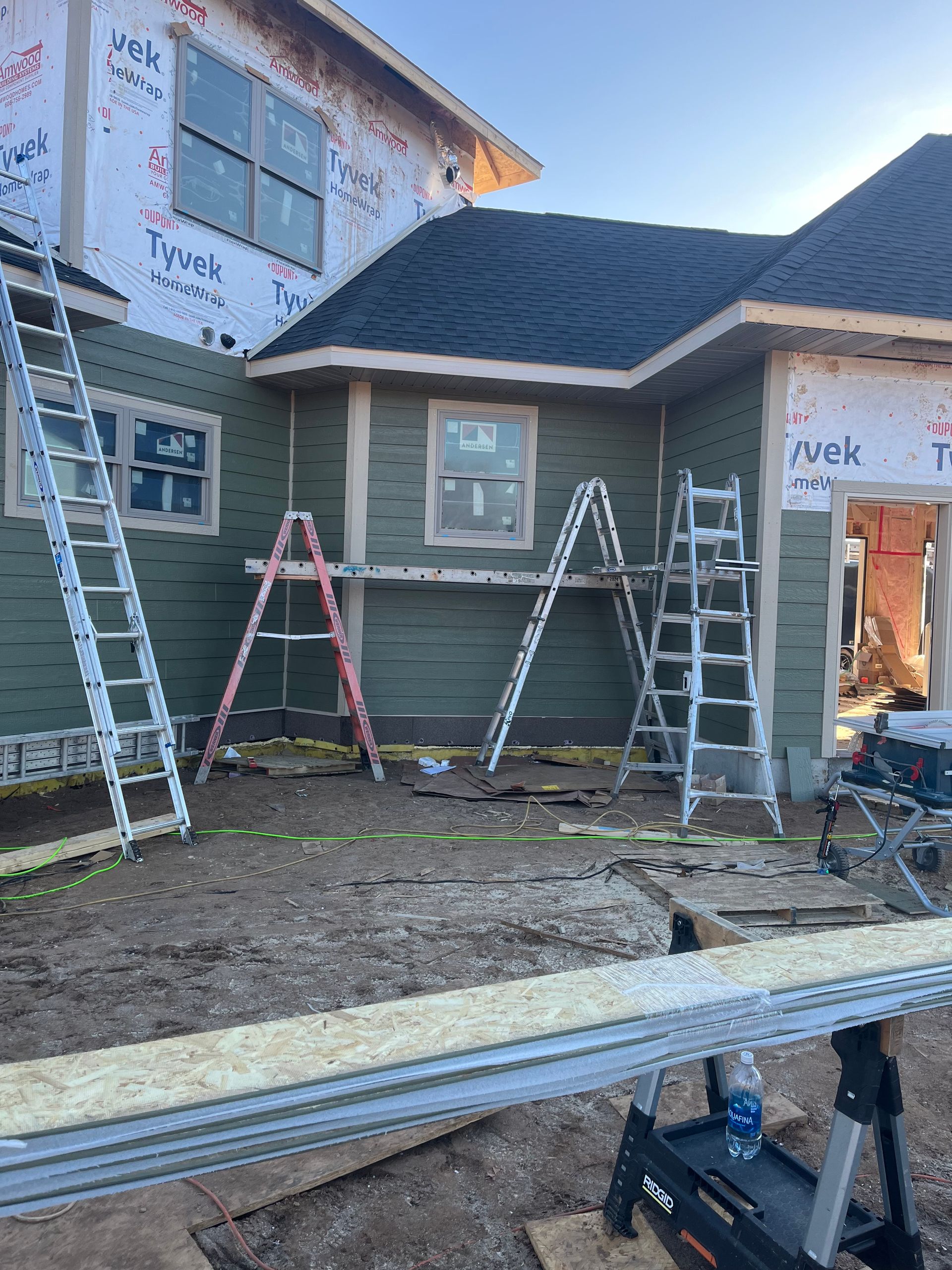 A large gray house with a black roof