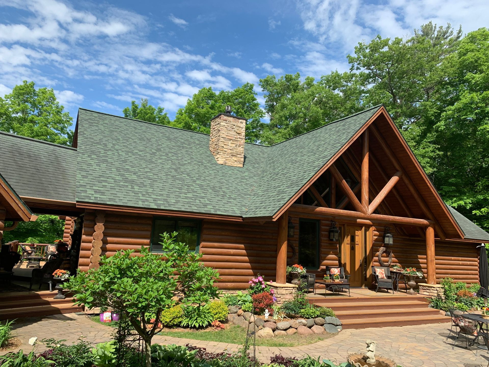 A large gray house with a black roof