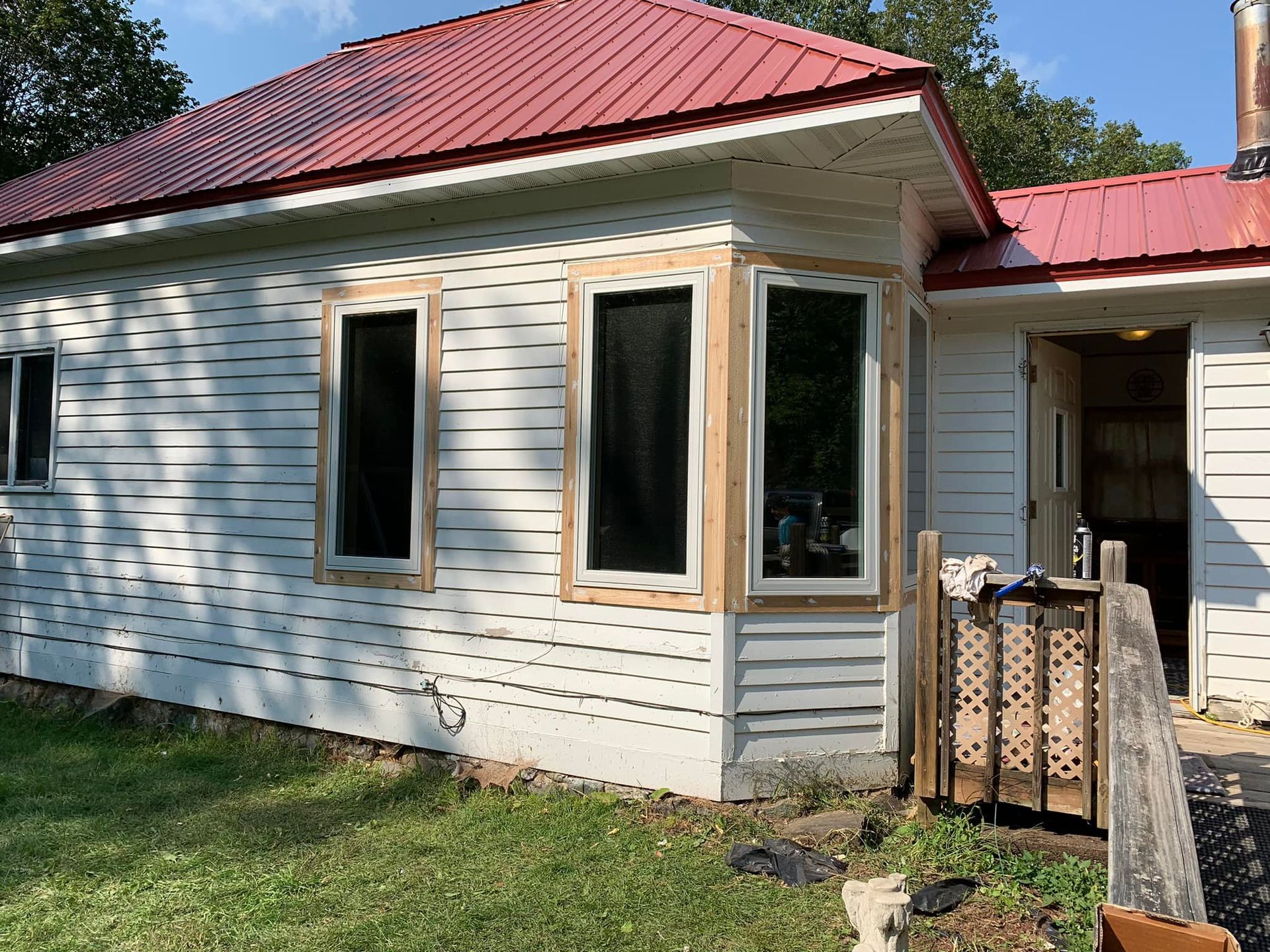 A large gray house with a black roof