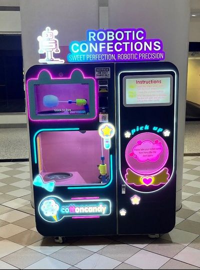 Robotic cotton candy machine dispensing fresh cotton candy at military base