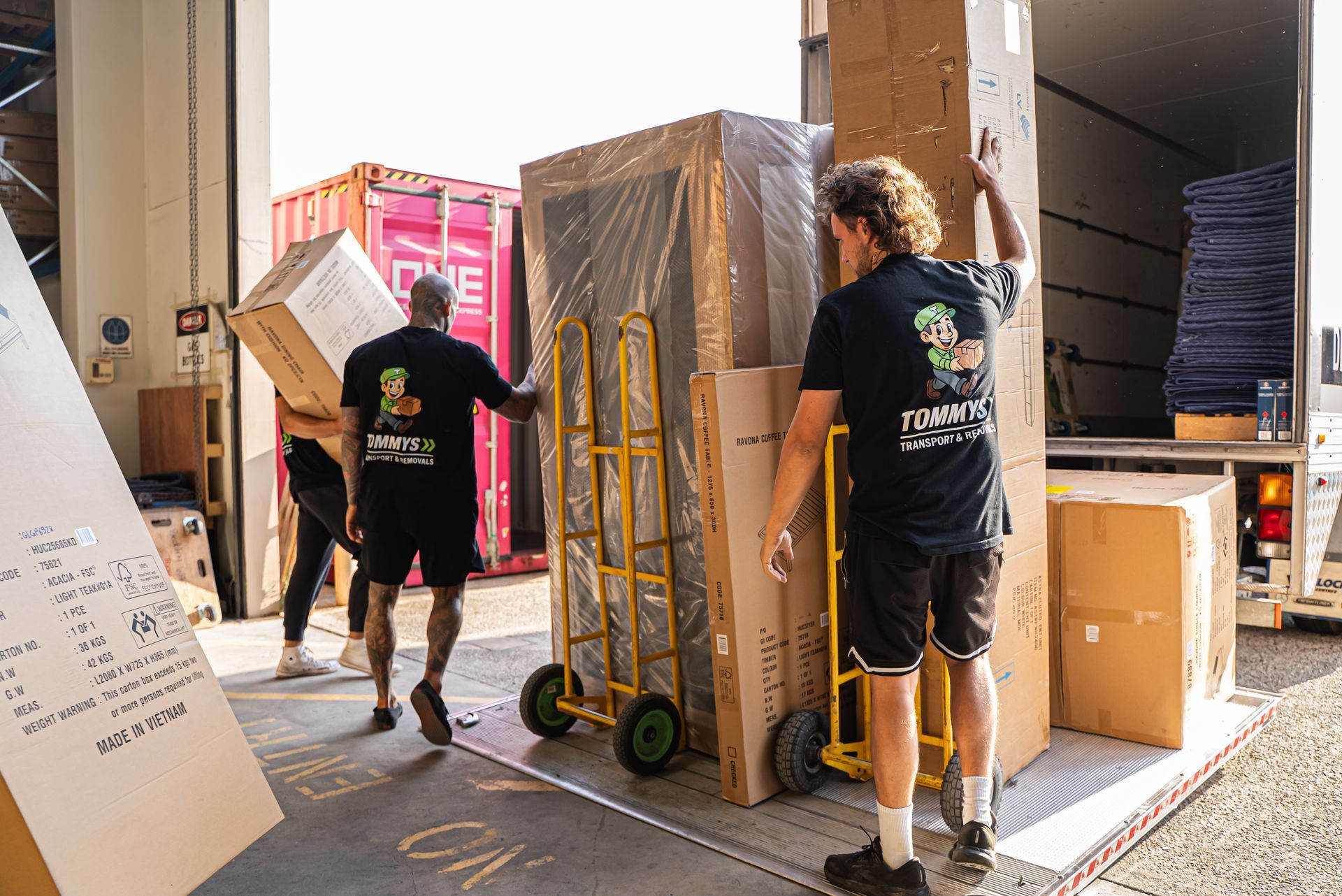 Tommy's Transport & Removals team carefully loading furniture for a Perth house move