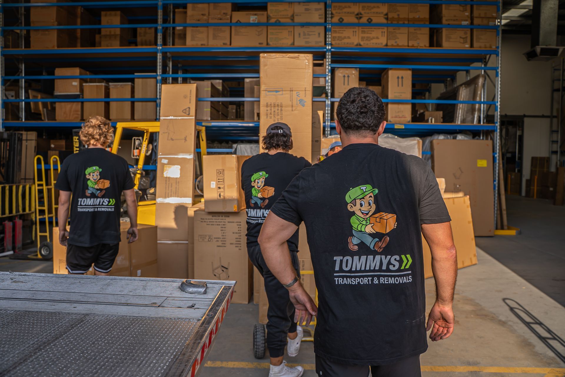 Tommy's Transport and Removals team unloading boxes for house move.