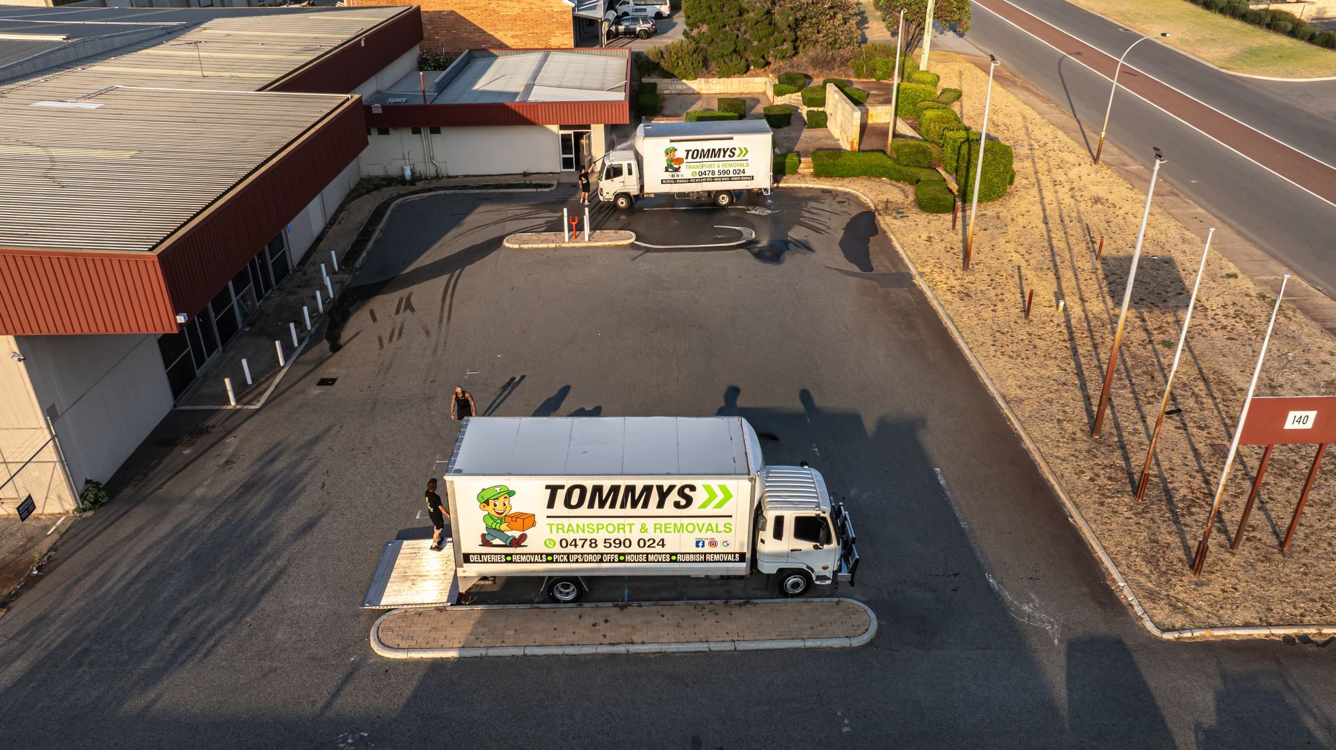 Three white moving trucks labeled 