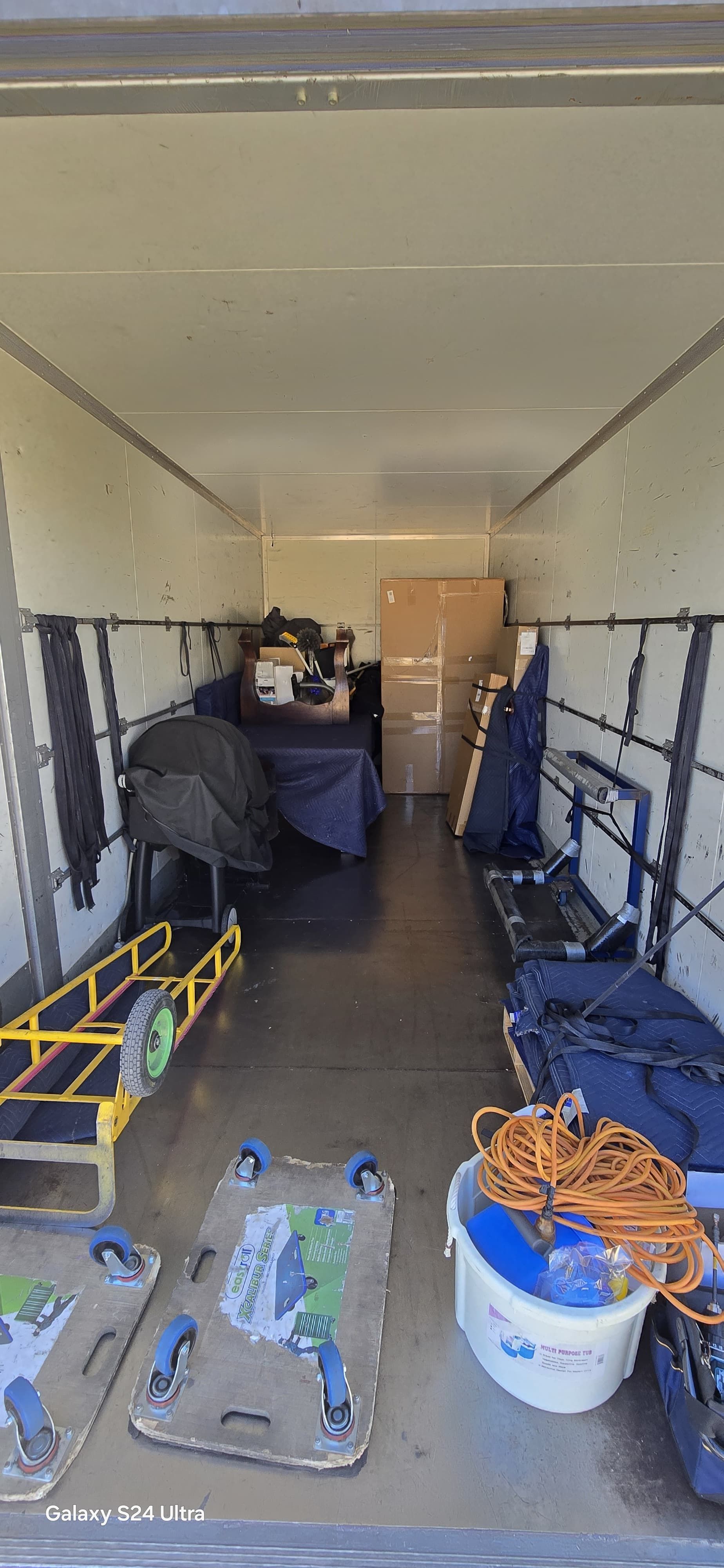 Interior of a moving truck filled with furniture all wrapped up safely.
