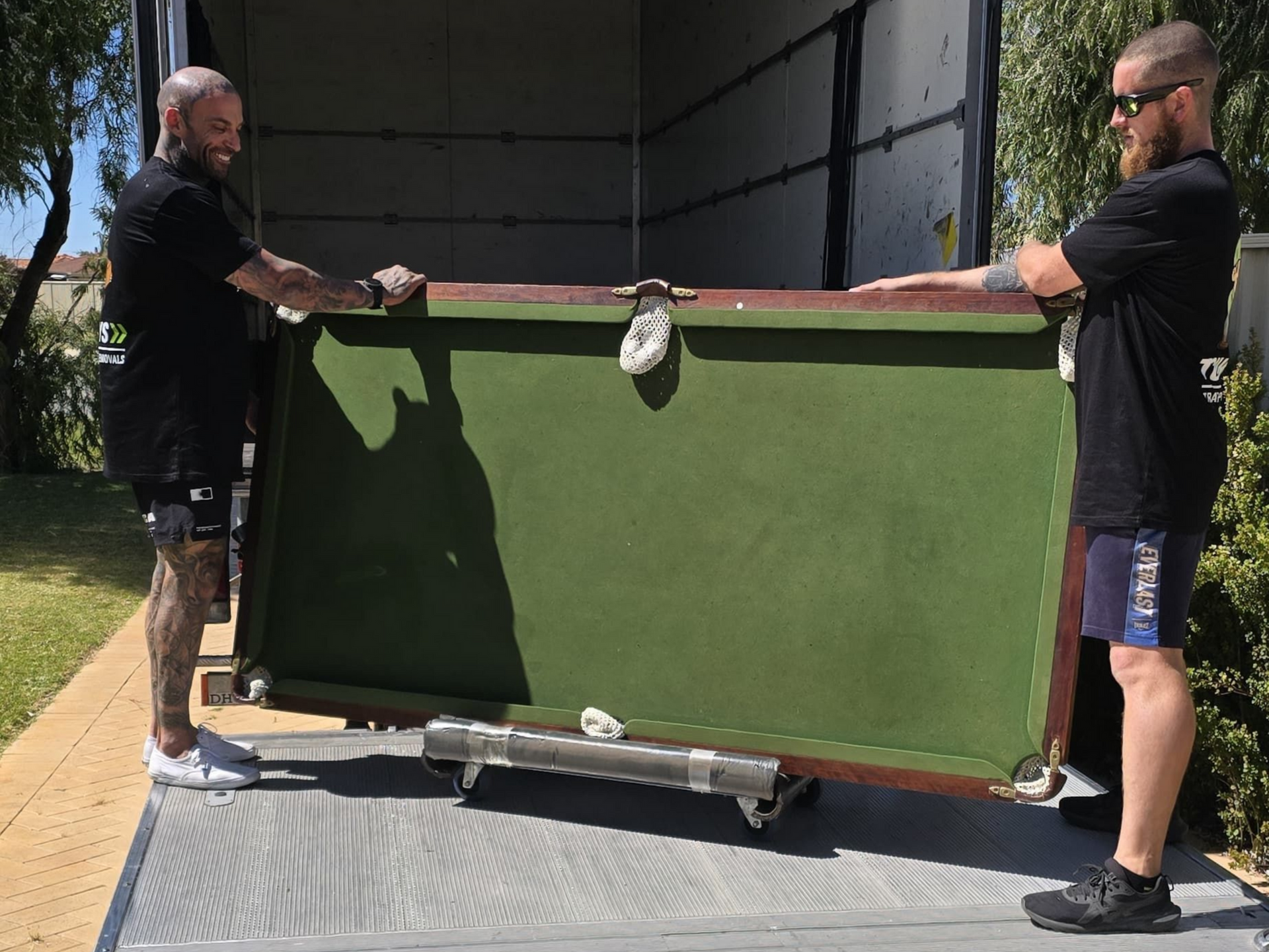 Tommy's Transport & Removals crew moving pool for customer into moving truck