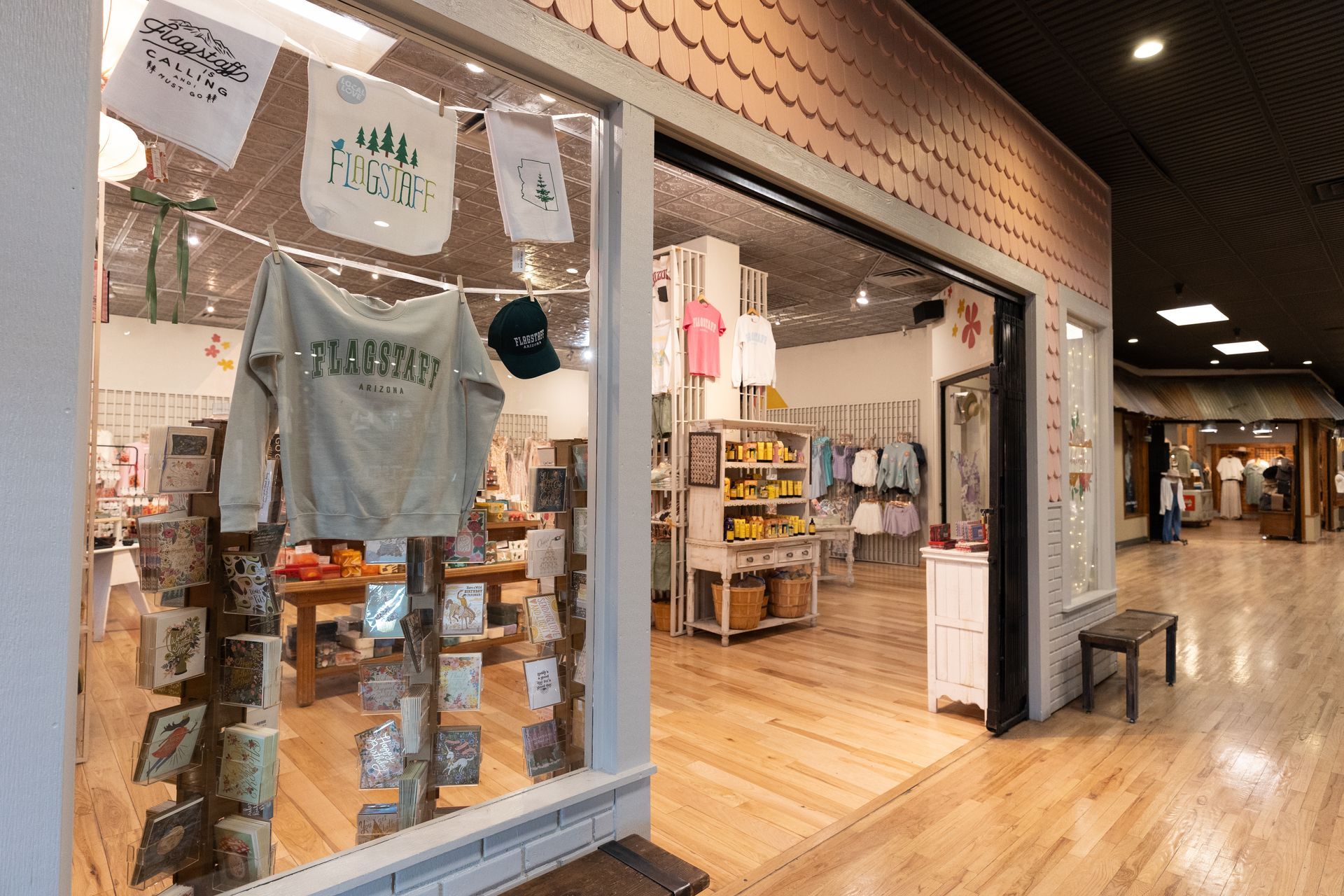 A store front with a t-shirt hanging in the window.