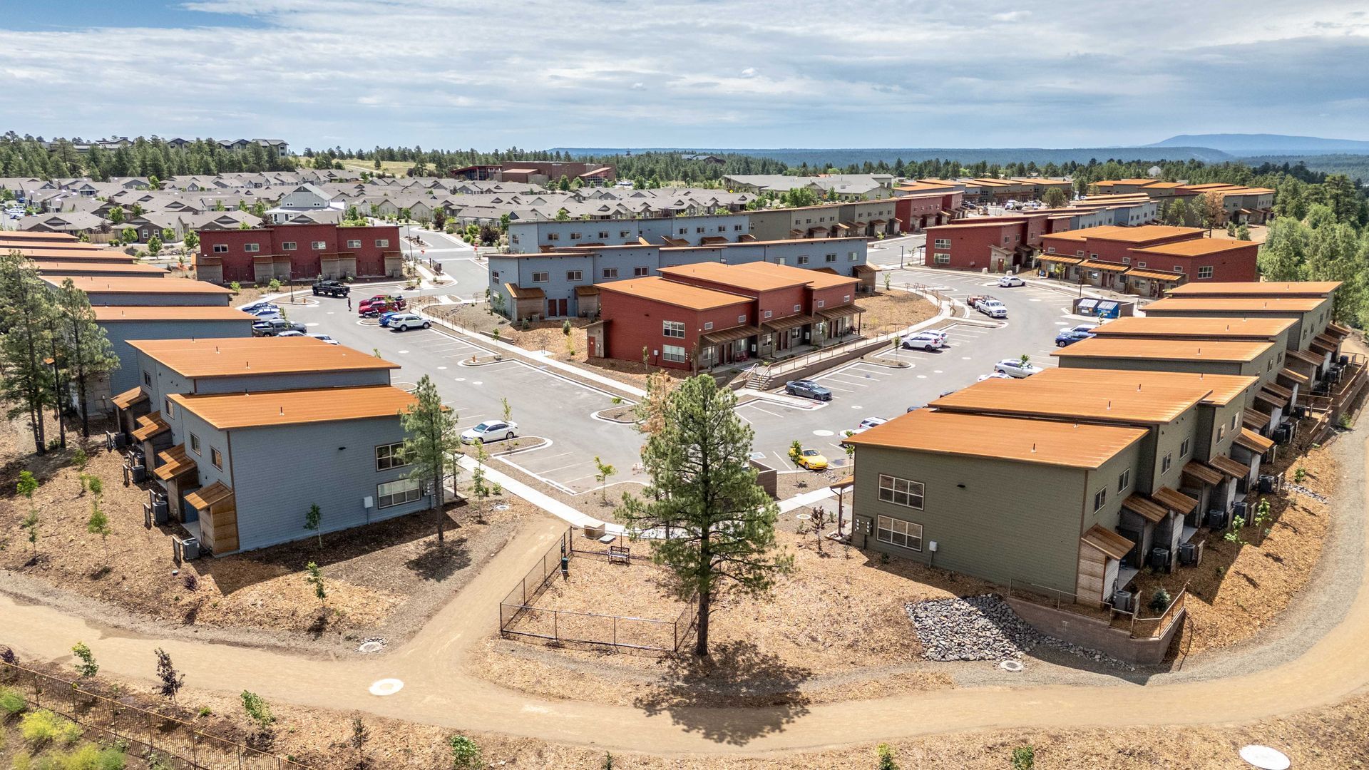 An aerial view of a residential area with lots of buildings and trees.