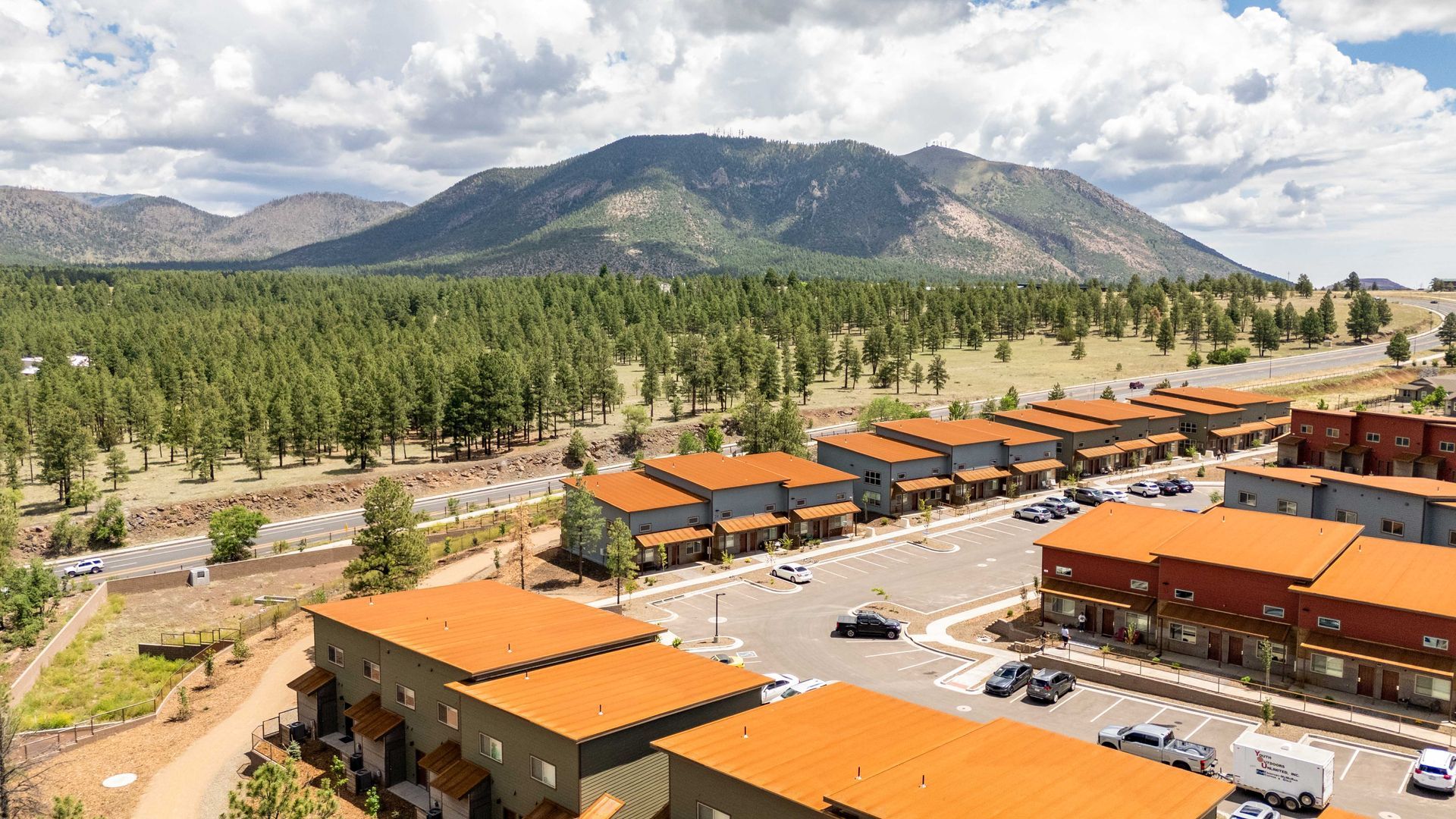 An aerial view of a residential area with mountains in the background.