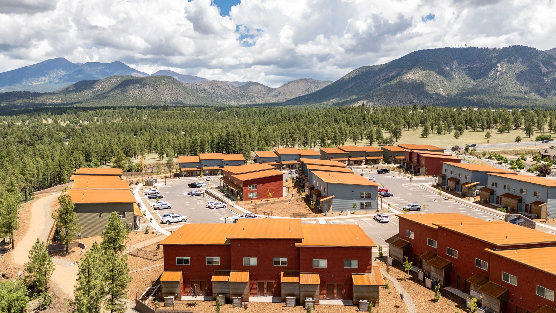 An aerial view of a residential area with mountains in the background.