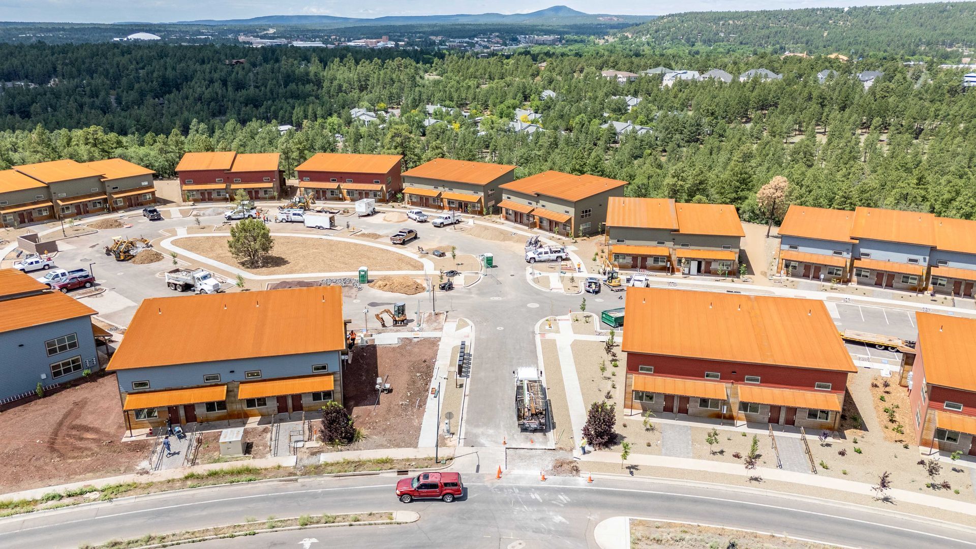 An aerial view of a residential area with orange roofs.