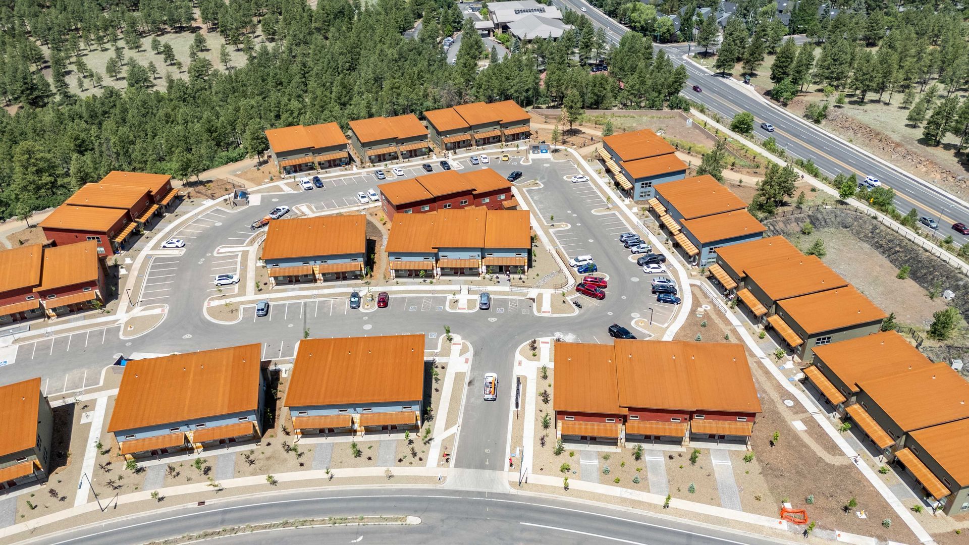 An aerial view of a shopping center with orange roofs