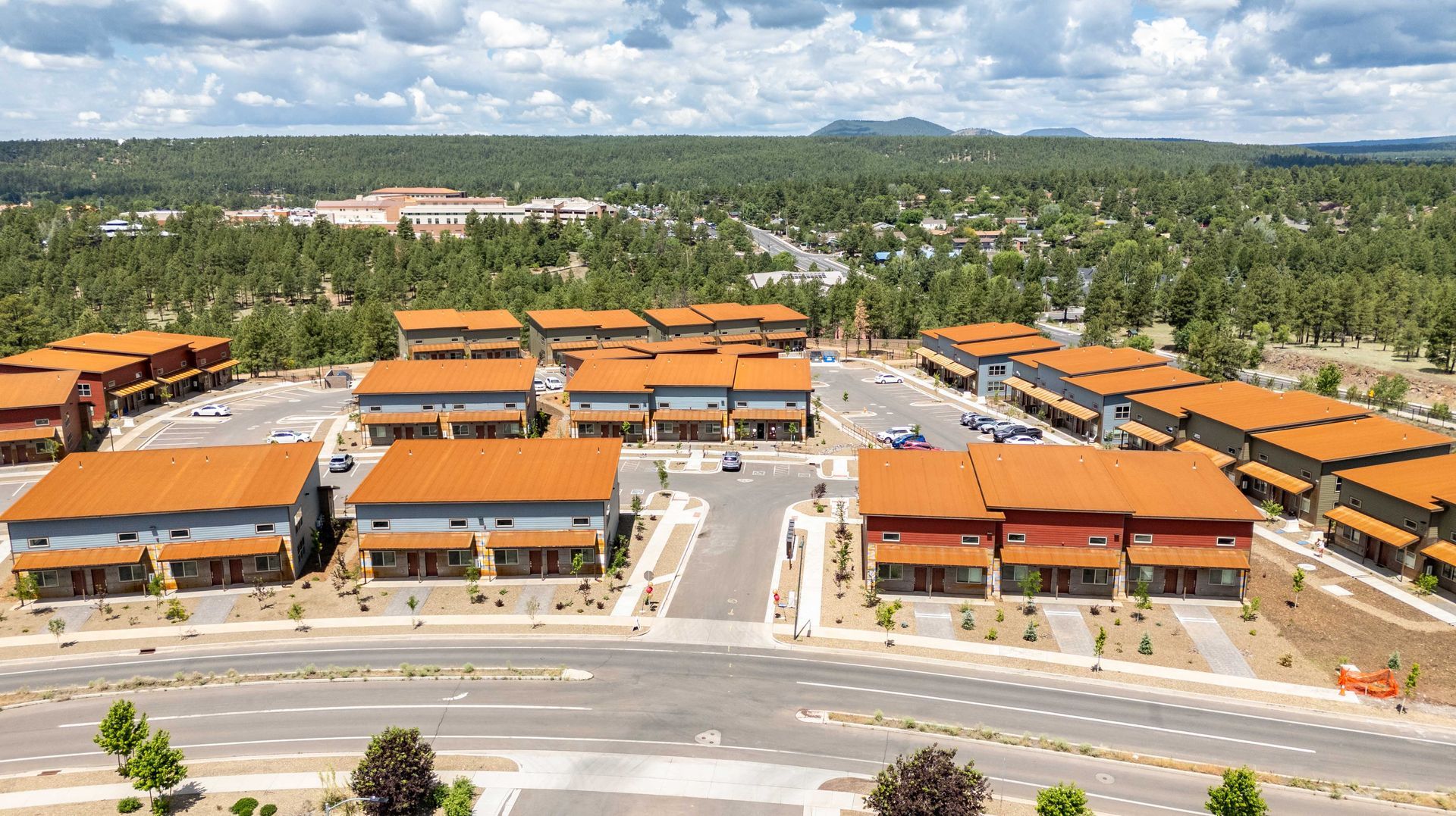 An aerial view of a residential area with lots of buildings and trees.