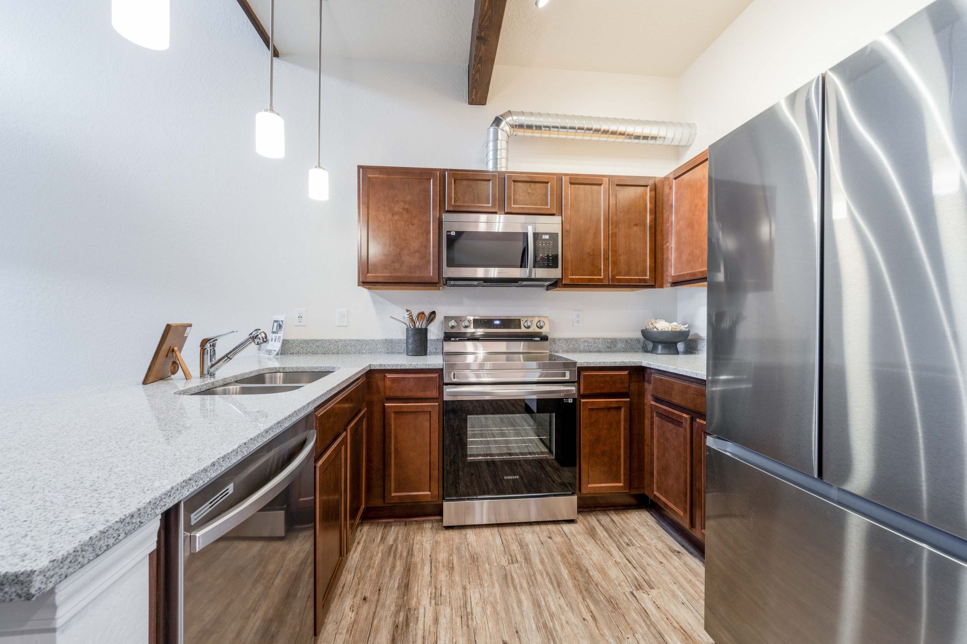 A kitchen with stainless steel appliances and wooden cabinets