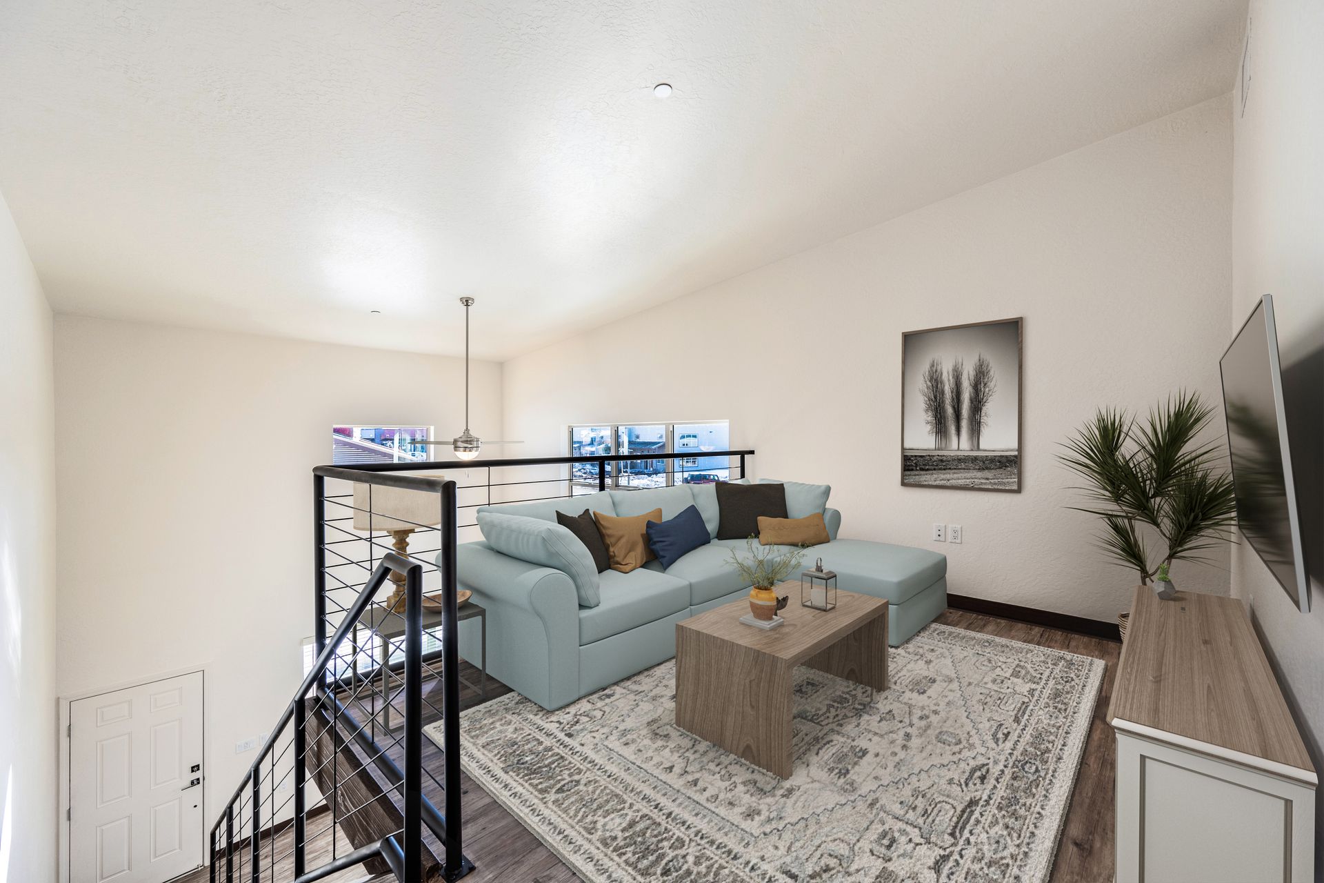 A living room with a couch , coffee table , and television.