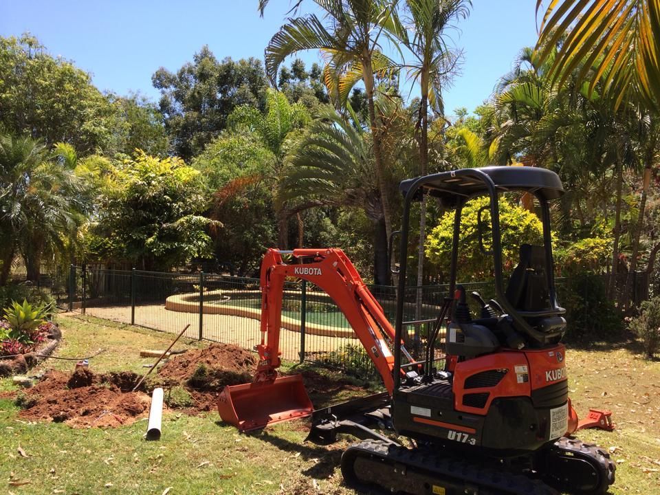 Orange Kubota Mini Excavator Near a Pool — Langley Plumbing in Mareeba, QLD