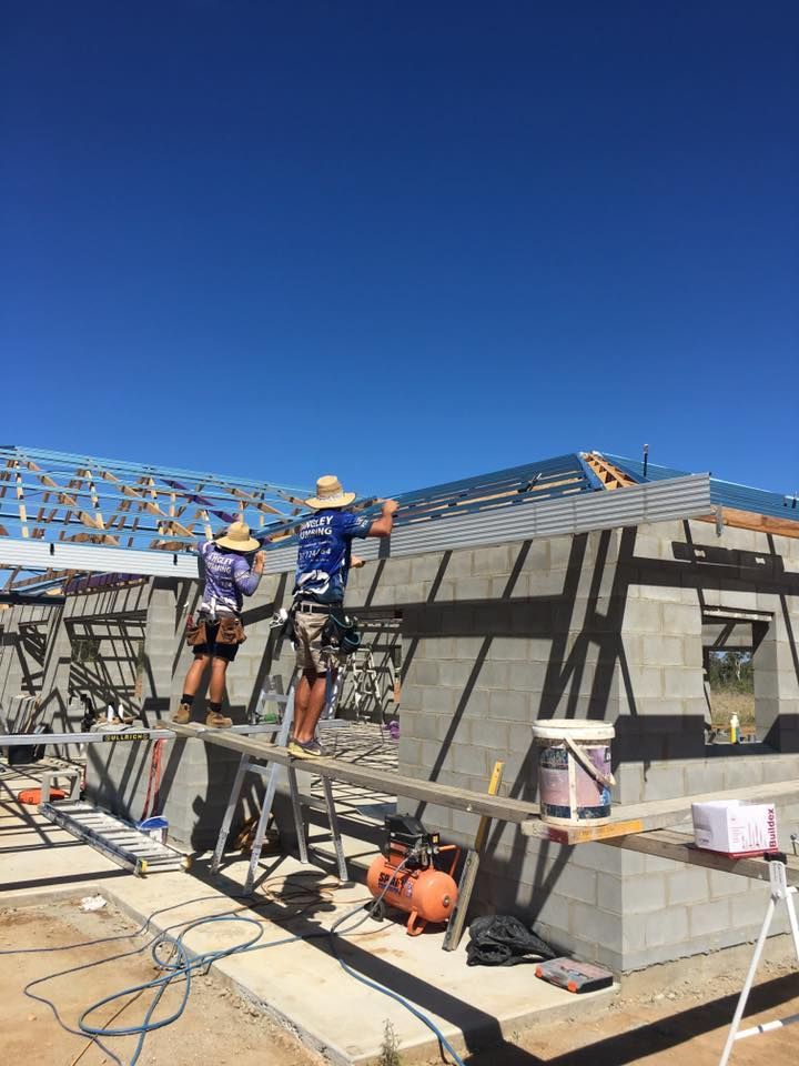 Two Construction Workers on Scaffolding, Building a House on a Sunny Day — Langley Plumbing in Mareeba, QLD