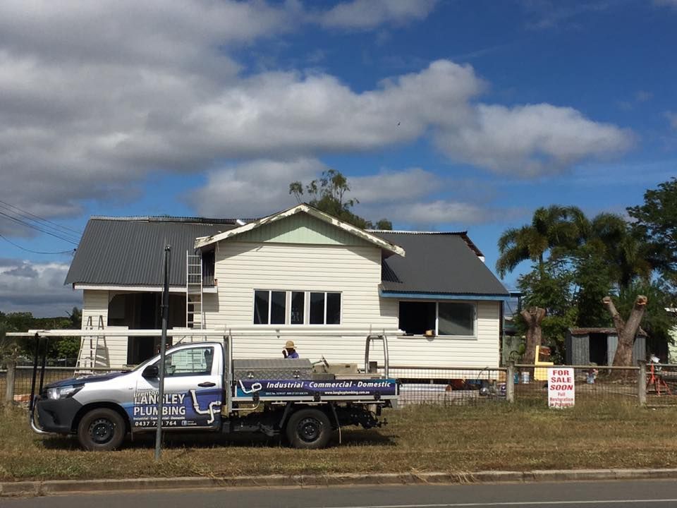 A White House With a Dark Gray Roof — Langley Plumbing in Mareeba, QLD