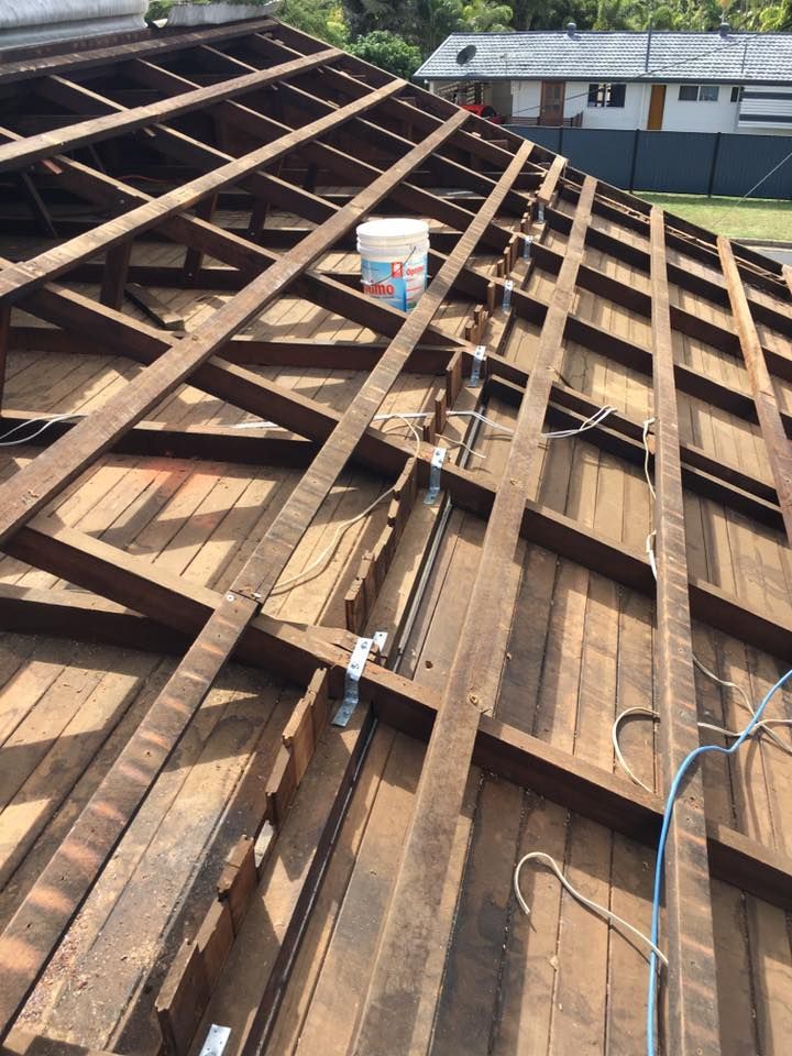 Wooden Roof Structure With Exposed Beams and a Paint Bucket — Langley Plumbing in Mareeba, QLD