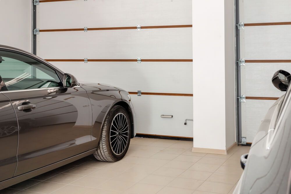 A Car Is Parked in A Garage Next to A Garage Door — ADAS Calibration Pty Ltd in Sutherland, NSW