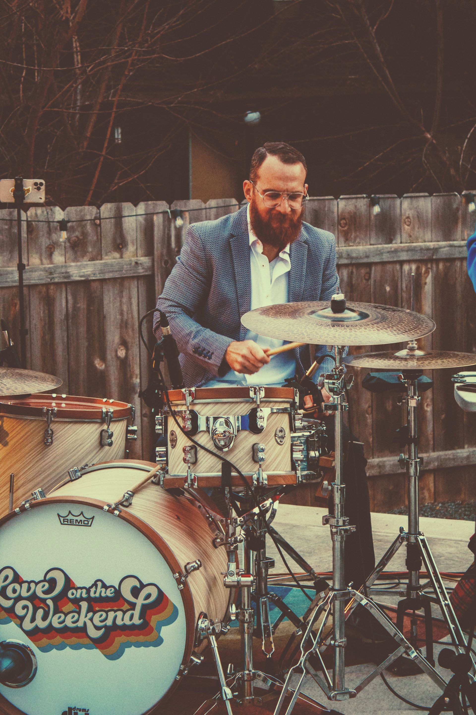 a man is playing drums in front of a drum.