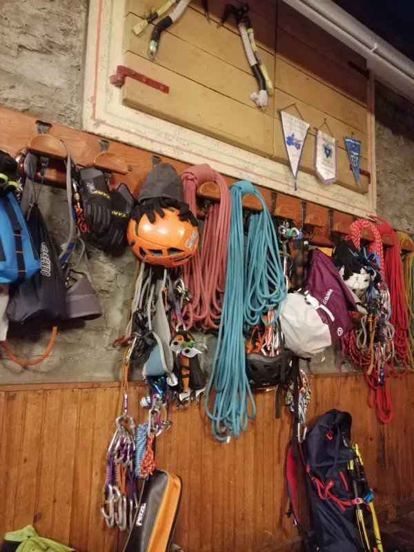 Un mucchio di attrezzatura da arrampicata è appeso a un muro