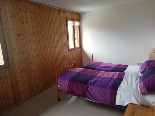 Una camera da letto con due letti e una finestra