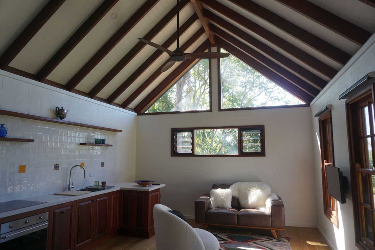 A living room with a vaulted ceiling and a couch