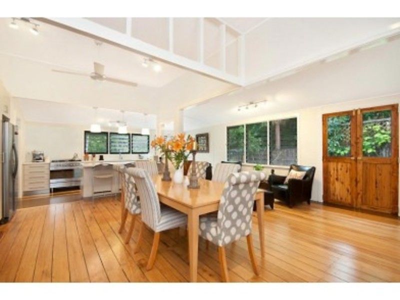 A dining room with a wooden table and chairs