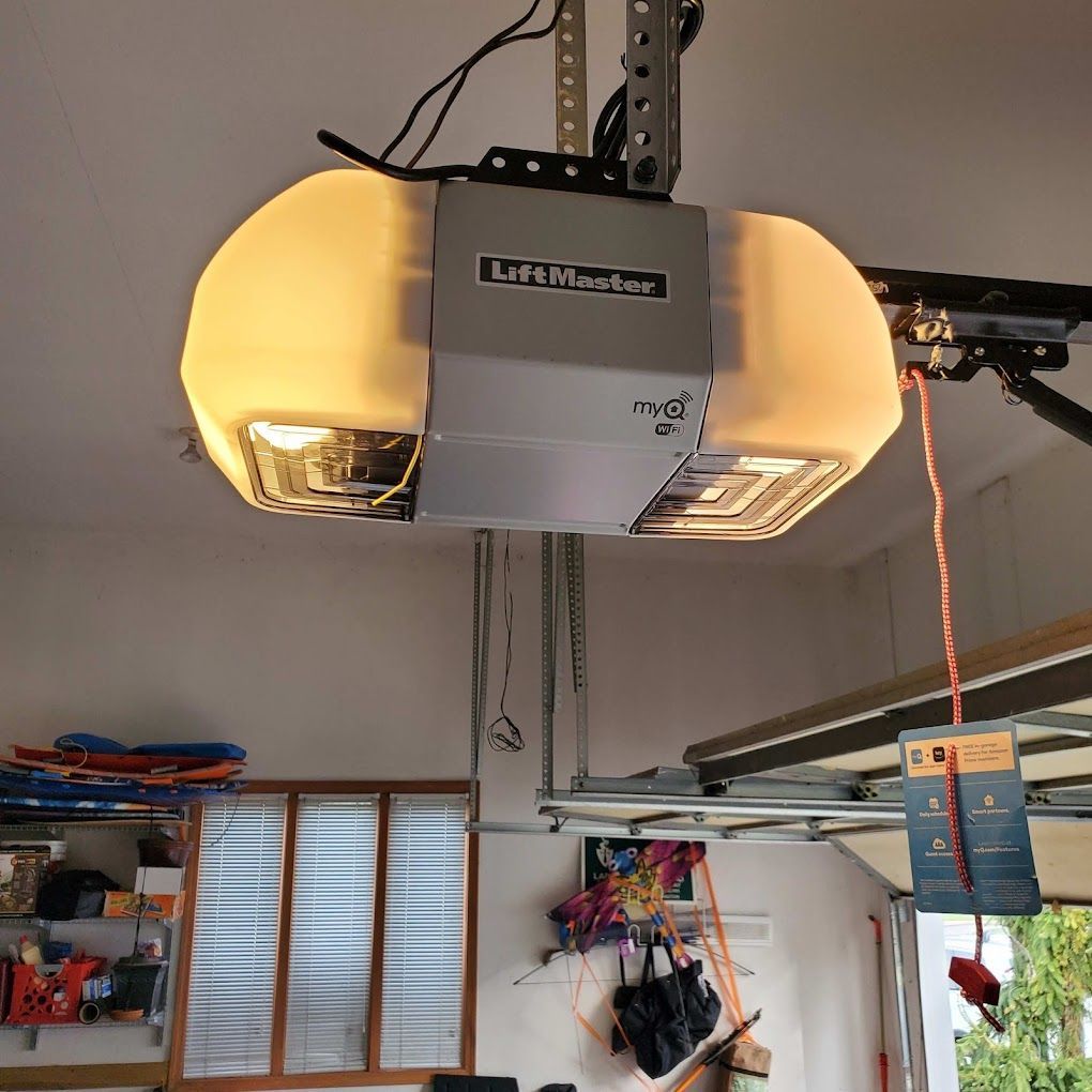 A life master garage door opener is hanging from the ceiling