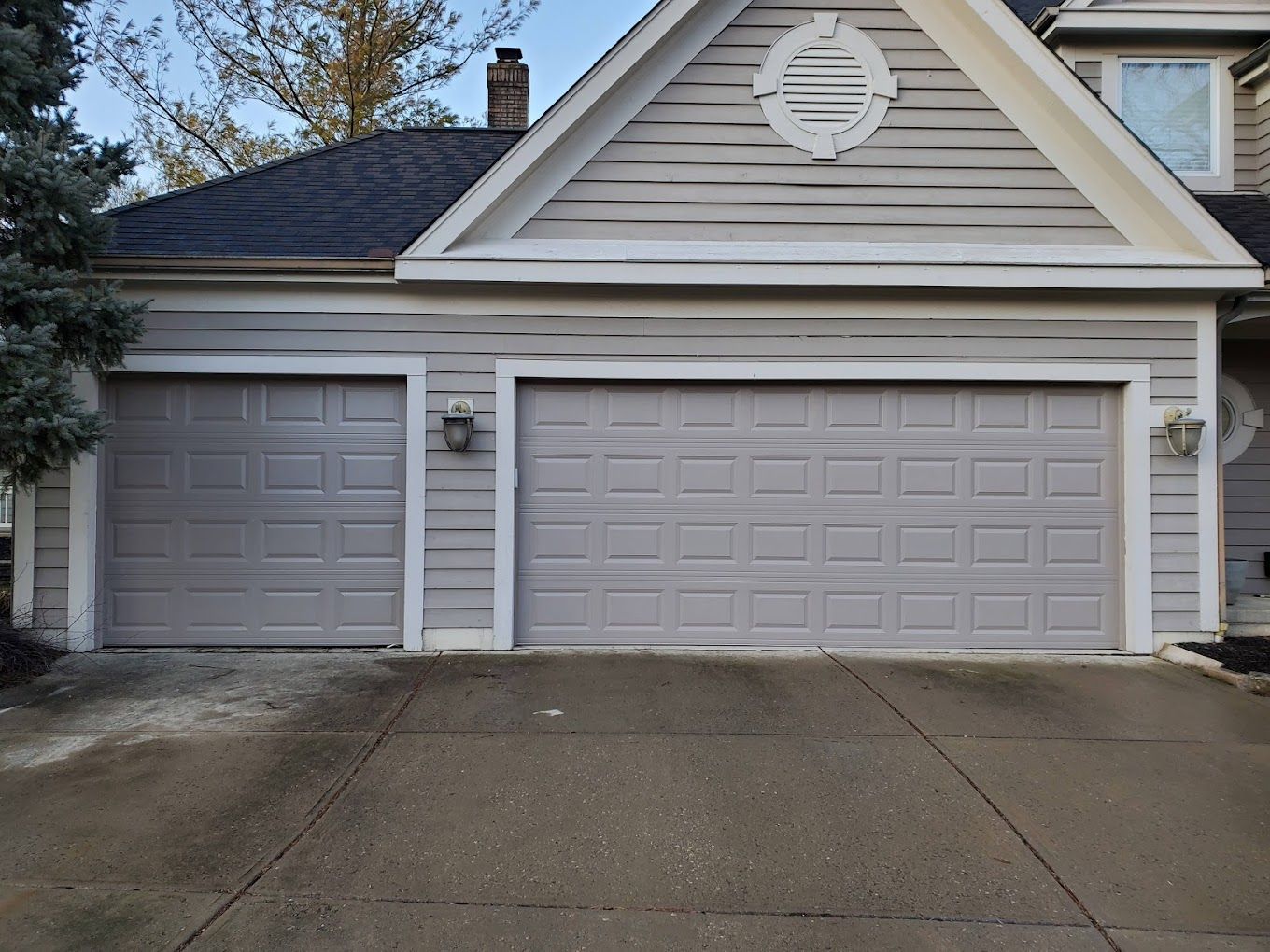 A house with two garage doors and a driveway