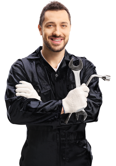 A man in a black jumpsuit is holding a wrench and smiling.