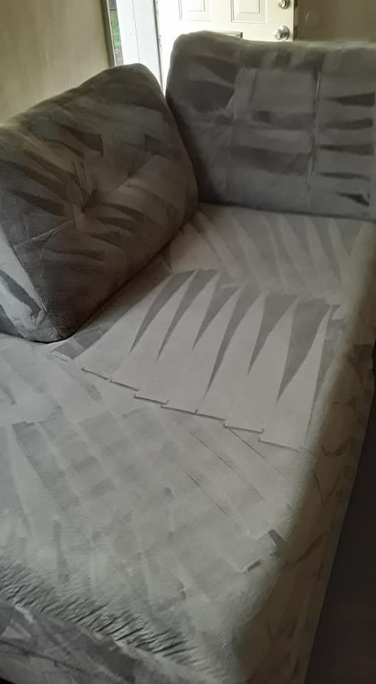 a grey couch with a geometric pattern on it