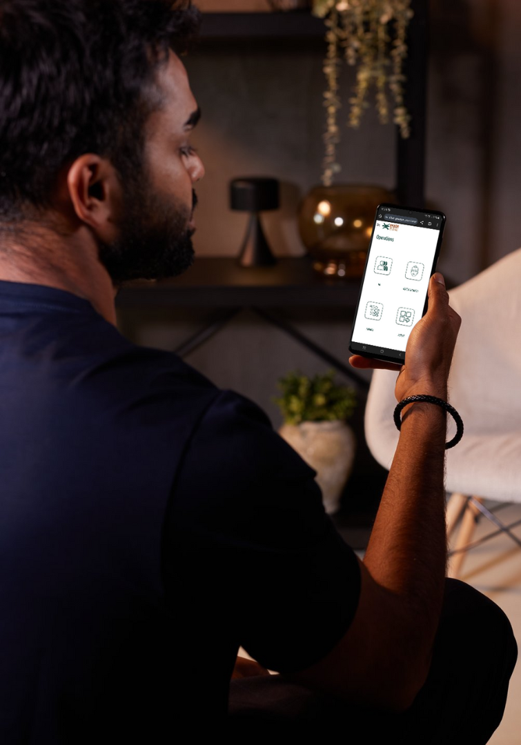 A man is holding a cell phone in his hand.