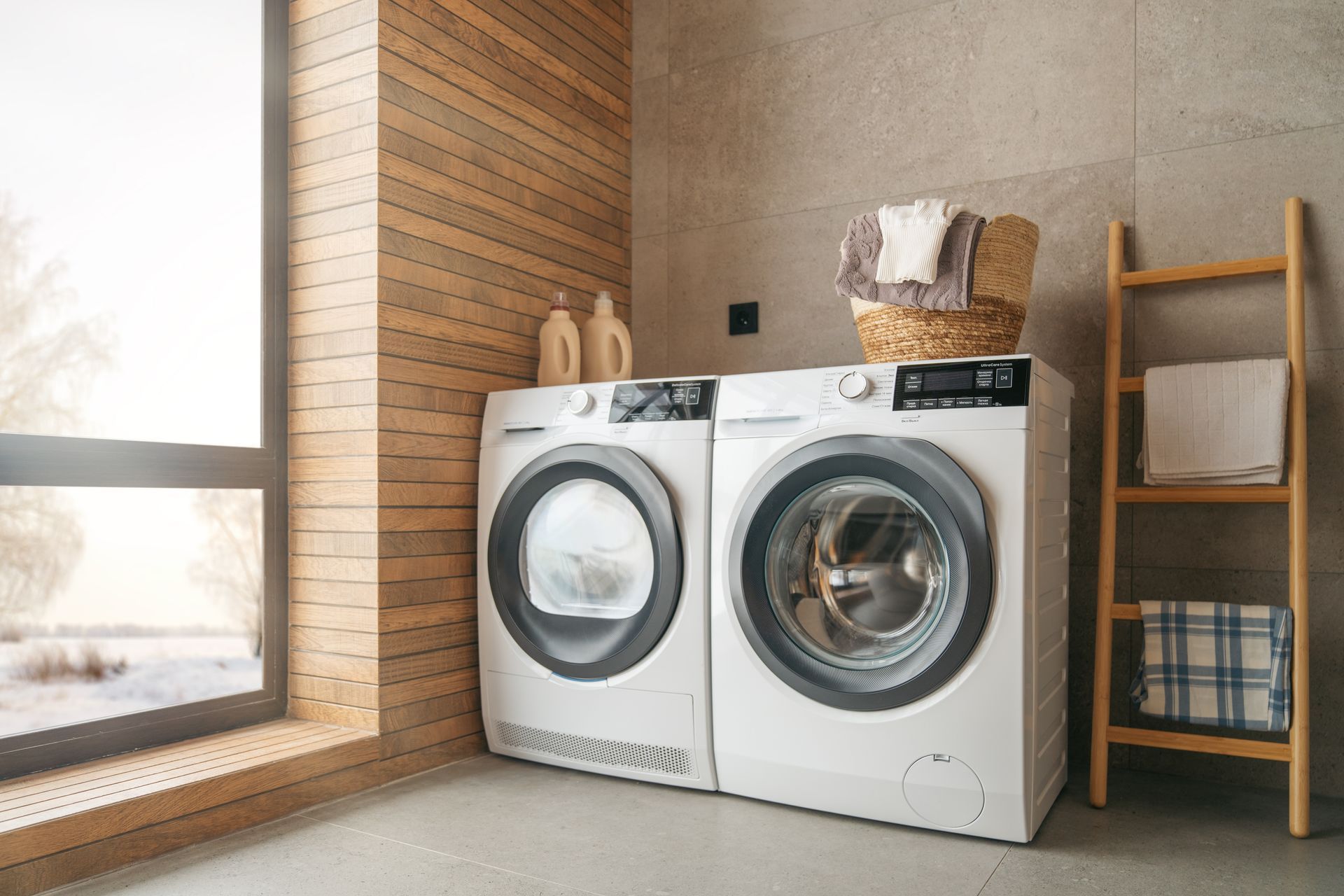 A washer and dryer are sitting next to each other in a laundry room.
