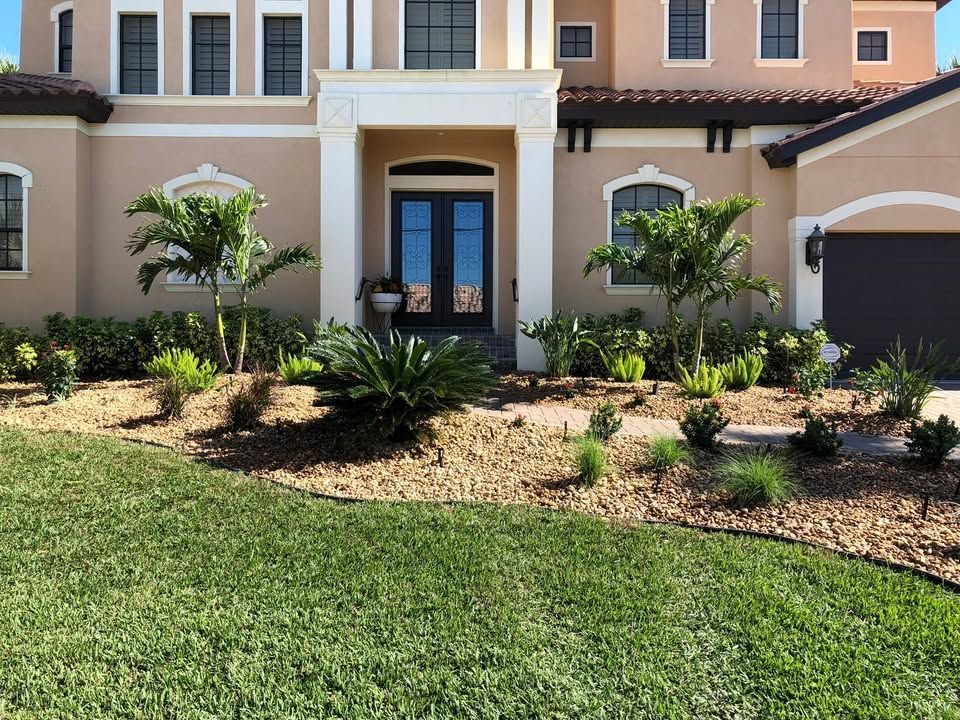 A large house with a lush green lawn in front of it