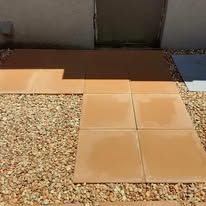 A bunch of tiles are sitting on top of a pile of gravel.