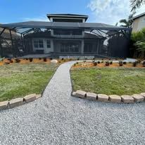 A large house with a screened in porch and a walkway leading to it.