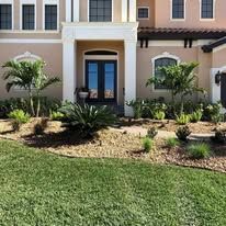 A large house with a lush green lawn in front of it.