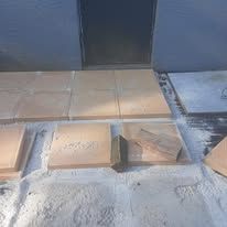 A bunch of tiles are sitting on top of each other on the ground.