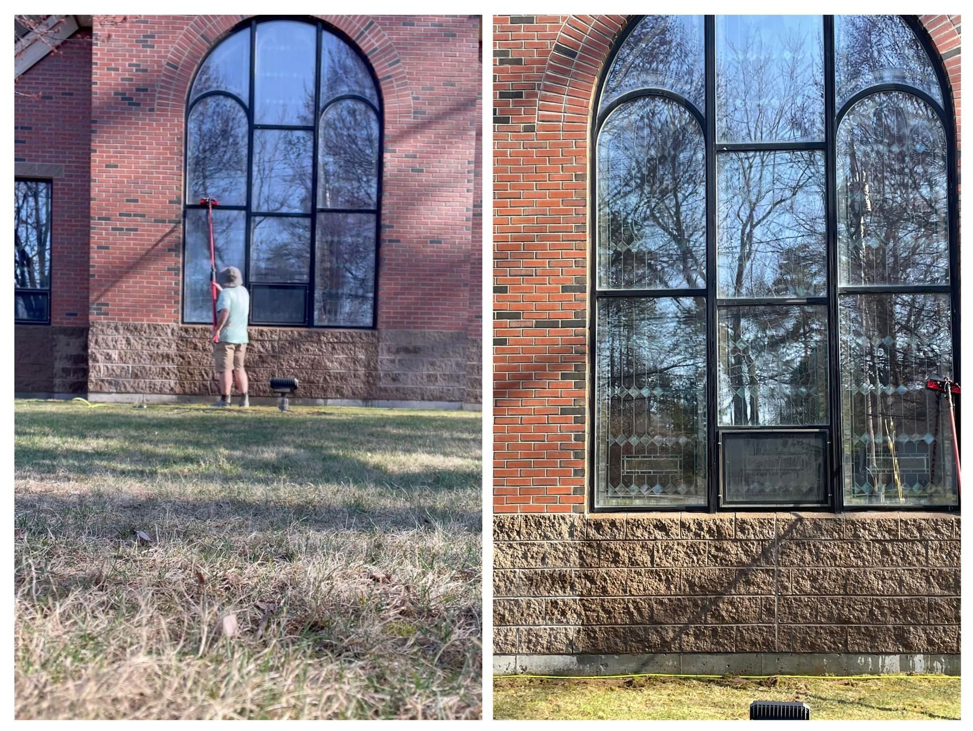 A man is cleaning the windows of a brick building.