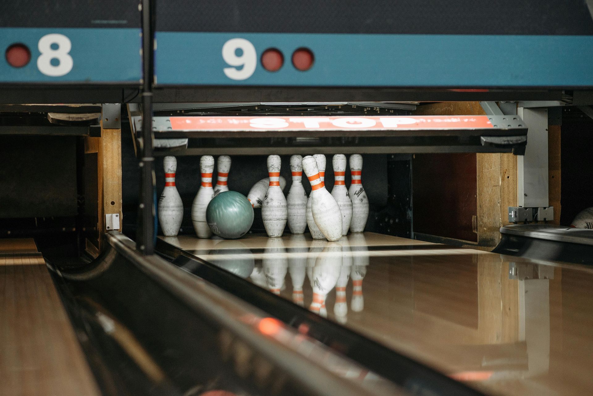Friends at a bowling alley, toasting drinks.