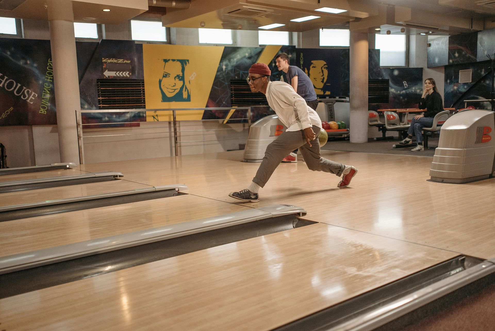 A man is playing bowling in a bowling alley