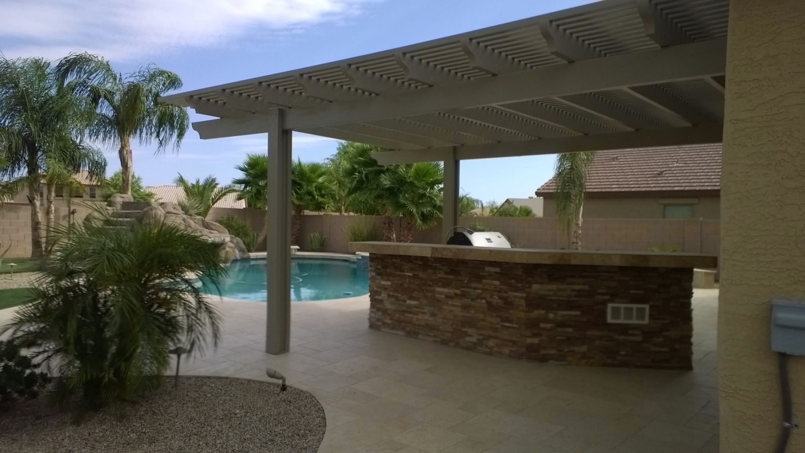 Sun City West golf club enhanced with an open-style lattice cover, providing a comfortable outdoor dining experience.