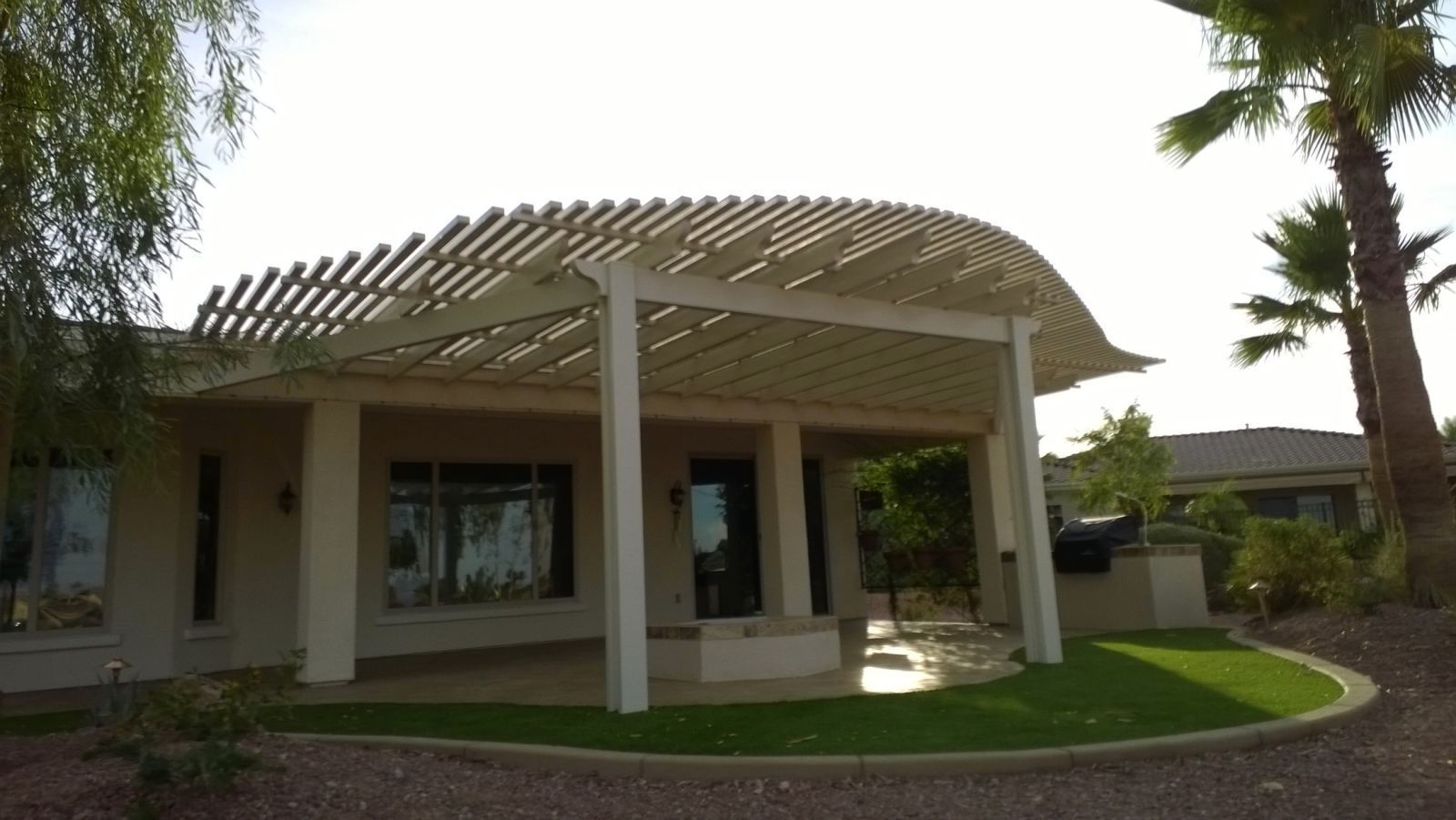Tonopah backyard oasis transformed with a Southwest Patio open lattice cover, offering a blend of shade and natural light.
