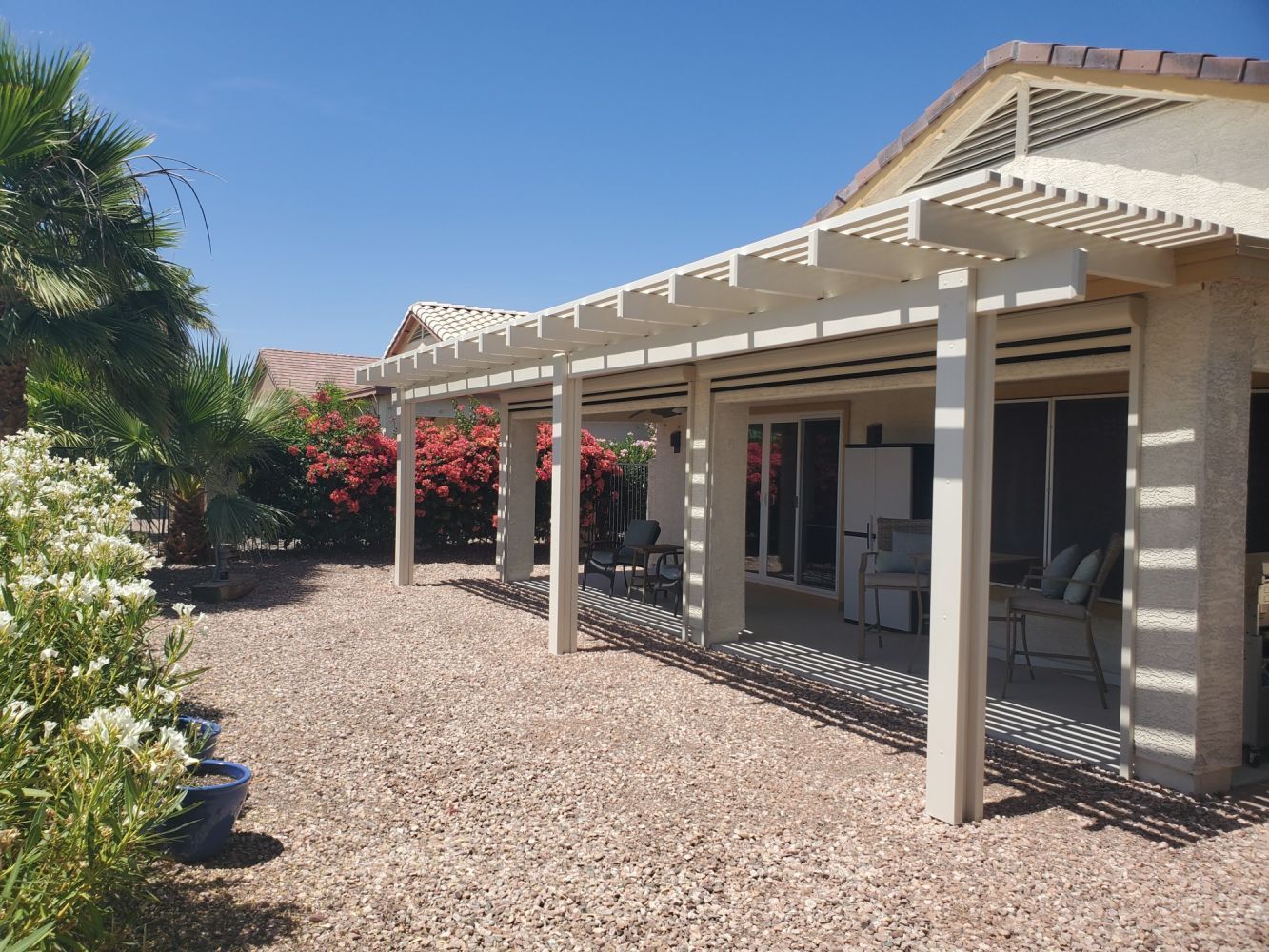 Wickenburg ranch accented with an open-style lattice cover, offering a breezy retreat from the Arizona sun.